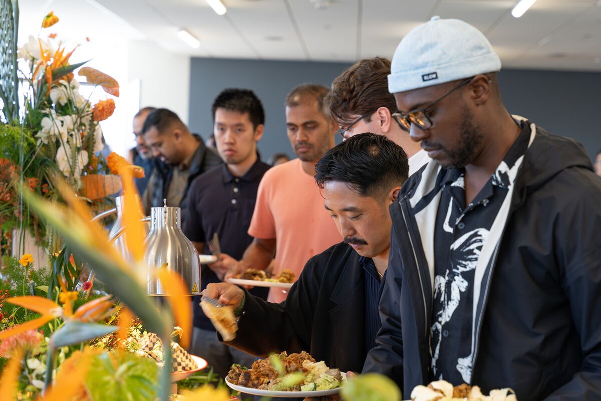Teammates serving themselves at a shared buffet lunch