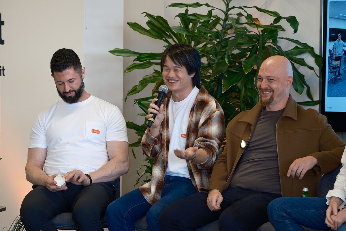 Three teammates laughing on stage during a Sprint Week panel